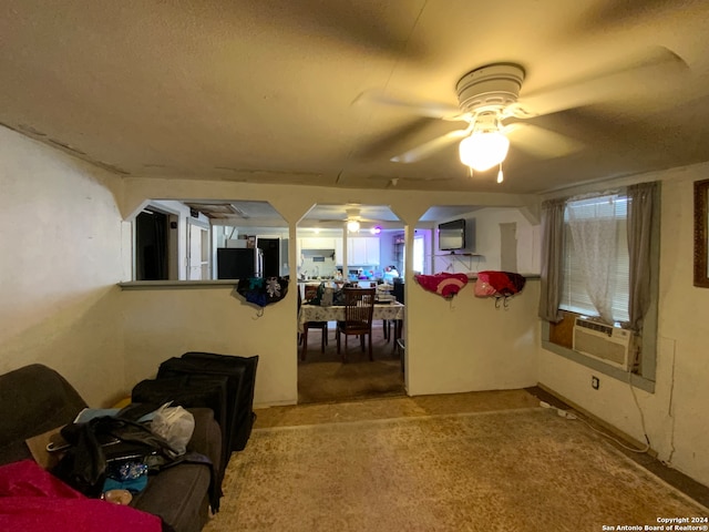 living room with cooling unit, carpet floors, and ceiling fan