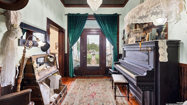 foyer featuring wood-type flooring and ornamental molding