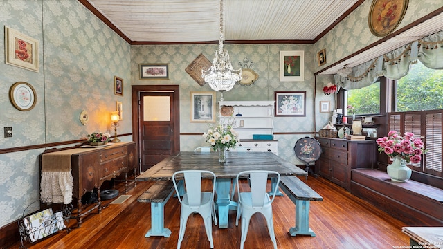 dining space with crown molding, a chandelier, and hardwood / wood-style floors