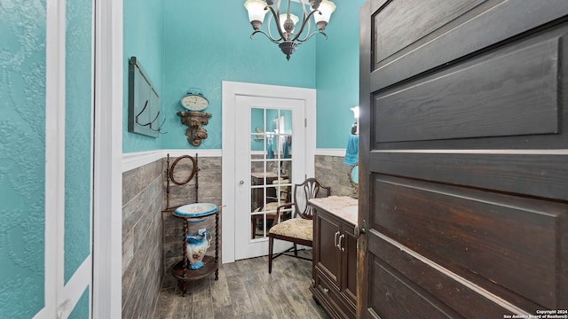 bathroom featuring vanity, tile walls, wood-type flooring, and an inviting chandelier