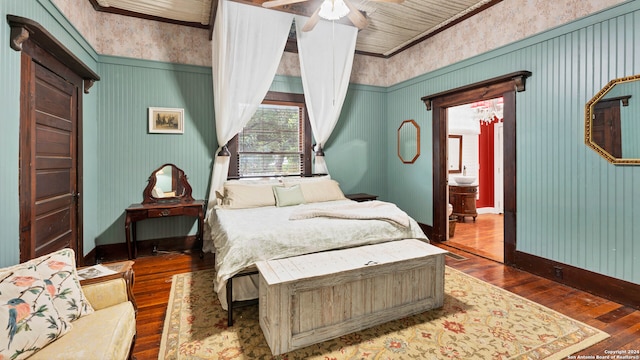 bedroom with ceiling fan, crown molding, and dark hardwood / wood-style floors