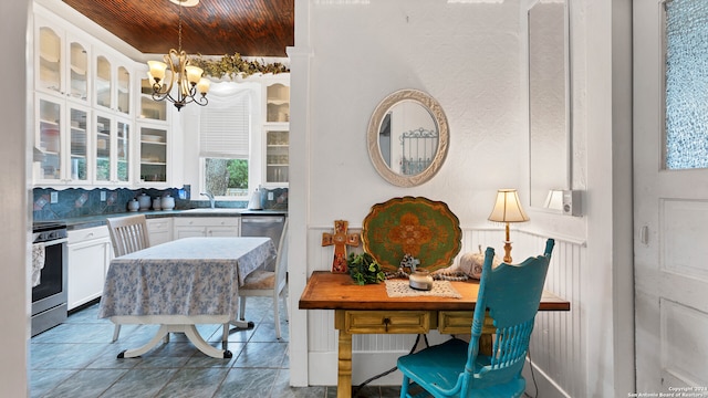 kitchen with wood ceiling, white cabinets, appliances with stainless steel finishes, a notable chandelier, and decorative light fixtures