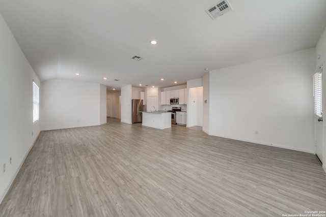 unfurnished living room with light hardwood / wood-style floors