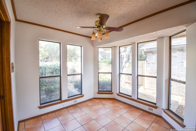 unfurnished sunroom featuring a wealth of natural light and ceiling fan