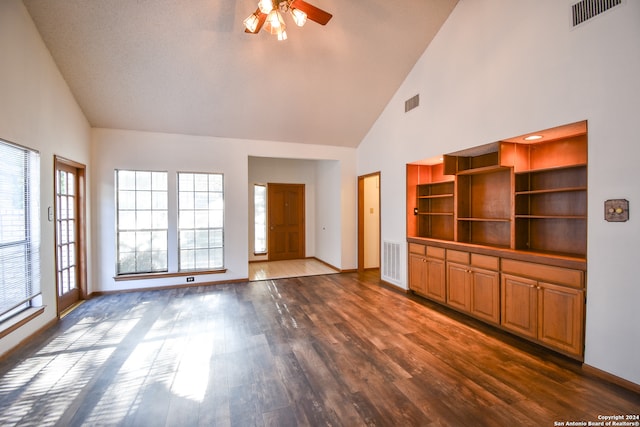 unfurnished living room featuring ceiling fan, high vaulted ceiling, a textured ceiling, and dark hardwood / wood-style floors