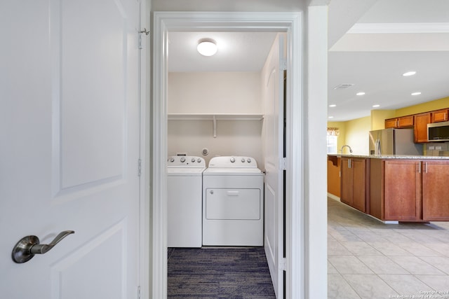 laundry area featuring crown molding, light tile patterned flooring, and independent washer and dryer