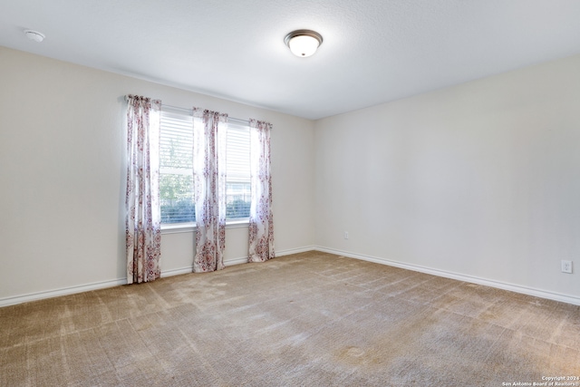 unfurnished room with light colored carpet