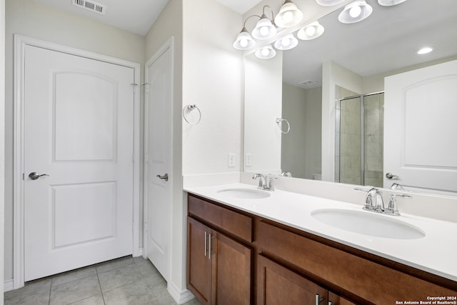 bathroom featuring vanity, walk in shower, and tile patterned floors