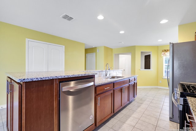 kitchen featuring light stone countertops, sink, appliances with stainless steel finishes, and beverage cooler