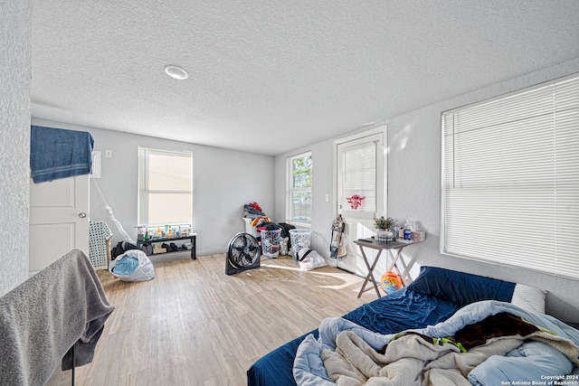 bedroom featuring a textured ceiling and hardwood / wood-style floors