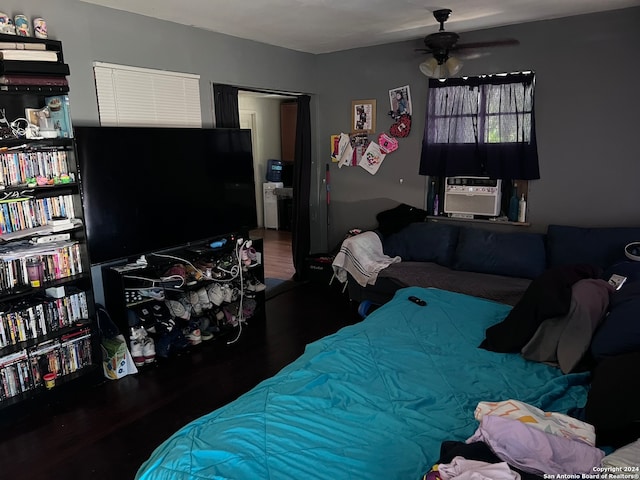 bedroom with ceiling fan, cooling unit, and dark hardwood / wood-style floors