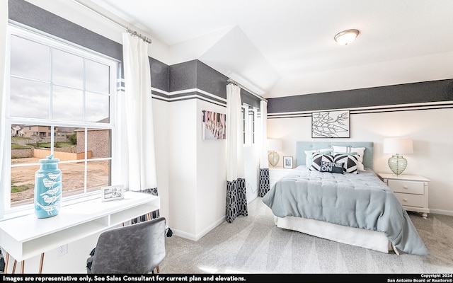 carpeted bedroom with lofted ceiling