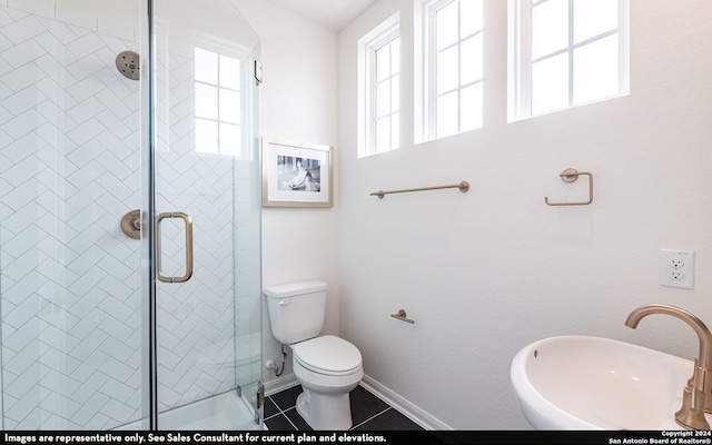 bathroom with toilet, sink, tile patterned floors, and a shower with door