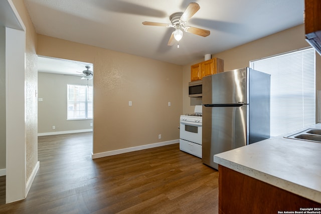 kitchen featuring appliances with stainless steel finishes, wood-type flooring, and ceiling fan