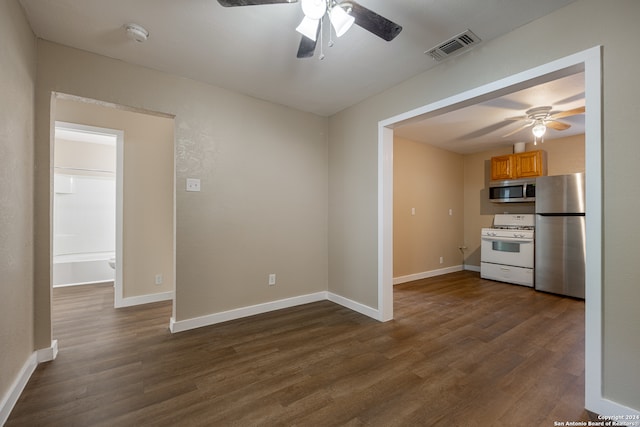 kitchen featuring dark wood-type flooring, appliances with stainless steel finishes, and ceiling fan