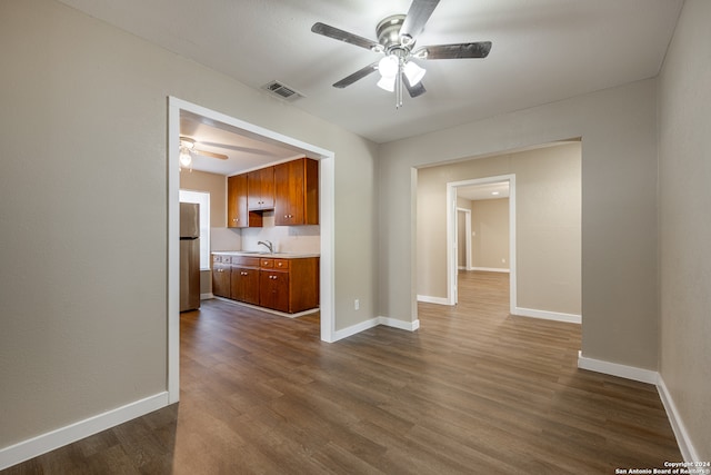 interior space with sink, ceiling fan, and dark hardwood / wood-style flooring