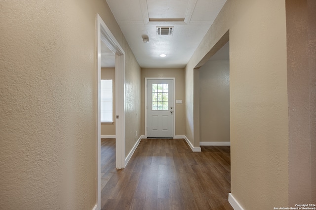 doorway featuring a textured ceiling and hardwood / wood-style flooring