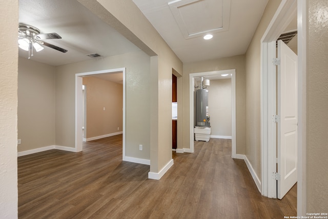 corridor featuring hardwood / wood-style flooring and water heater