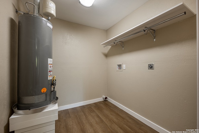 laundry room with hookup for an electric dryer, water heater, hookup for a washing machine, and dark hardwood / wood-style flooring