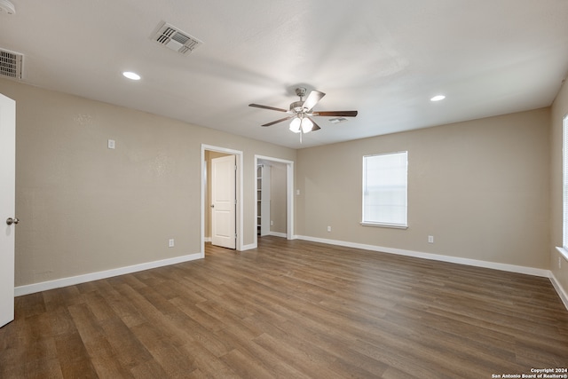 unfurnished bedroom with dark hardwood / wood-style floors and ceiling fan