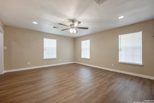 spare room with dark hardwood / wood-style floors and ceiling fan