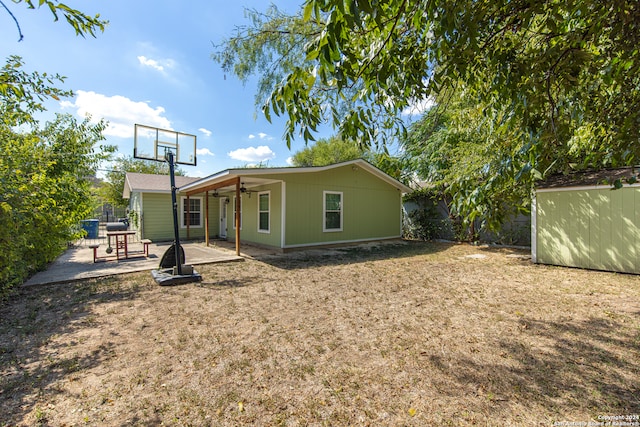 back of house featuring a patio area, a shed, and ceiling fan