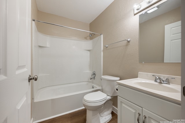 full bathroom with toilet, hardwood / wood-style floors, vanity, and bathing tub / shower combination