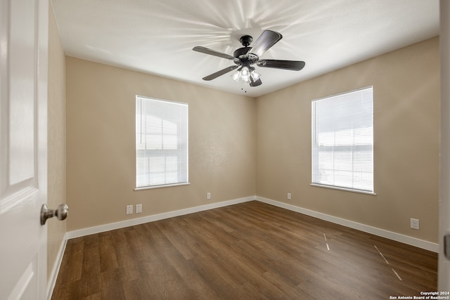 unfurnished room featuring ceiling fan and dark hardwood / wood-style flooring