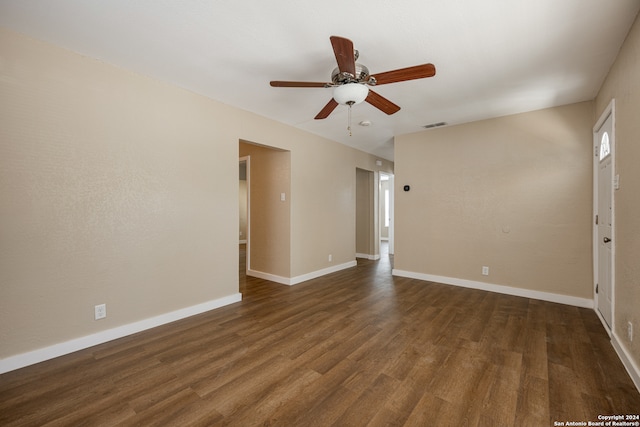 empty room featuring ceiling fan and dark hardwood / wood-style flooring