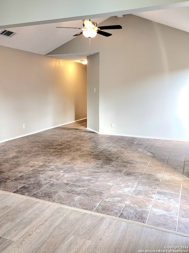 unfurnished room featuring hardwood / wood-style floors, vaulted ceiling, and ceiling fan