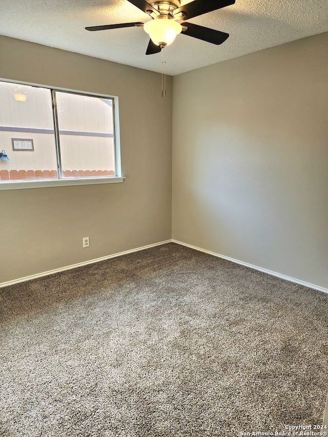 spare room with ceiling fan, carpet flooring, and a textured ceiling