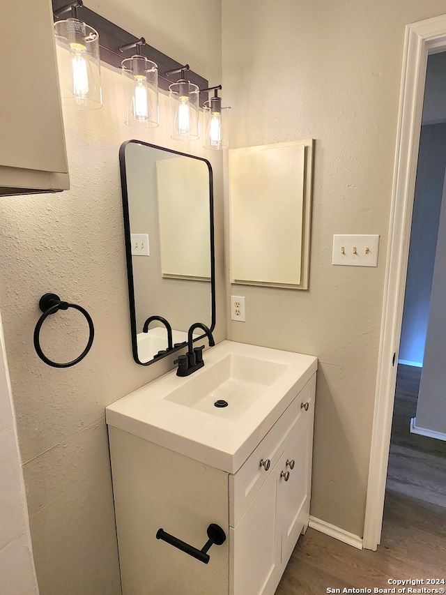 bathroom with vanity and hardwood / wood-style floors