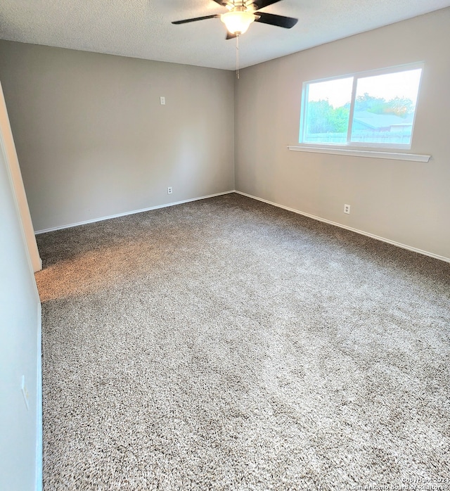 spare room with carpet floors, a textured ceiling, and ceiling fan