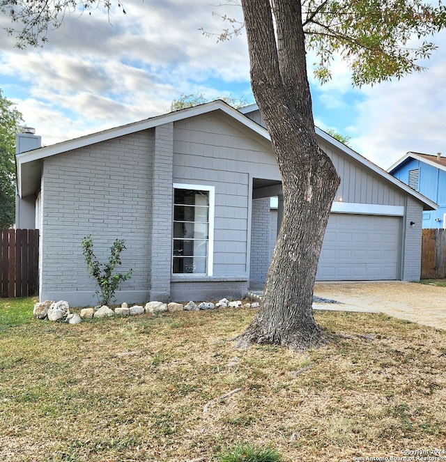 view of front of house featuring a front yard and a garage