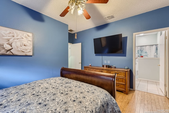 bedroom featuring light hardwood / wood-style floors, a textured ceiling, and ceiling fan