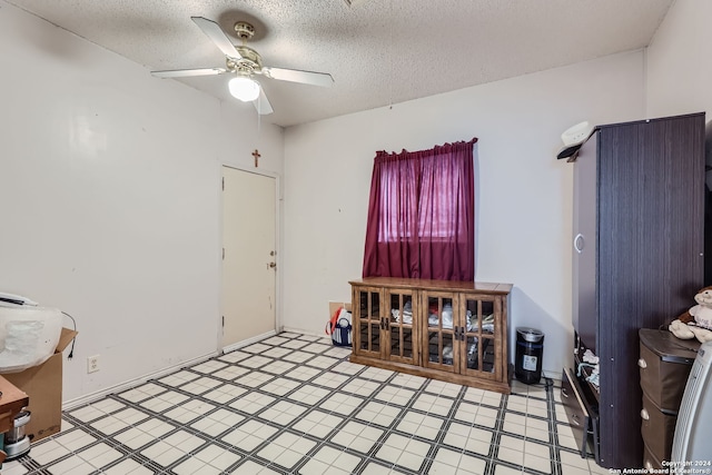 misc room featuring a textured ceiling and ceiling fan