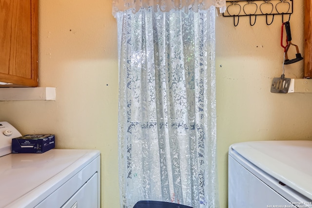 bathroom featuring vanity and washing machine and clothes dryer