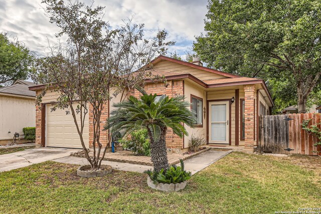 view of front of house featuring a front yard and a garage