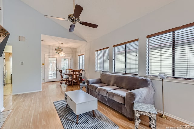 living room featuring high vaulted ceiling, light hardwood / wood-style floors, and ceiling fan