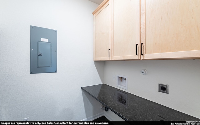 laundry room featuring electric panel, hookup for a washing machine, electric dryer hookup, and cabinets