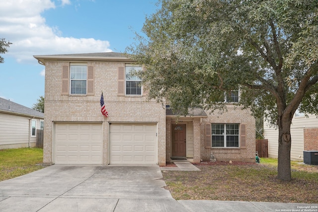 view of front of property with central AC and a garage