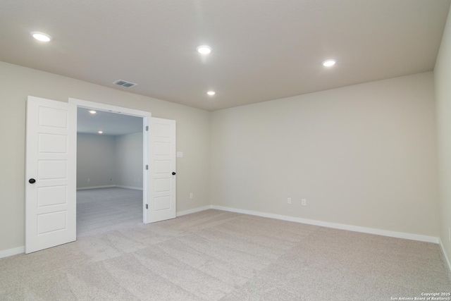 unfurnished room featuring recessed lighting, visible vents, baseboards, and light colored carpet