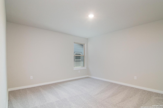 empty room with baseboards and carpet flooring