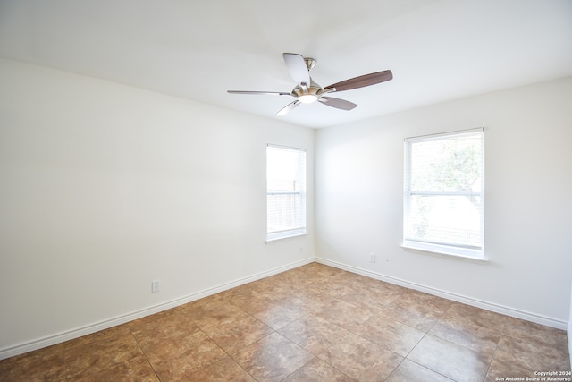 unfurnished room with light tile patterned flooring and ceiling fan