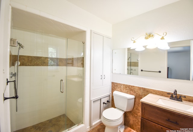 bathroom with a shower with door, toilet, and vanity