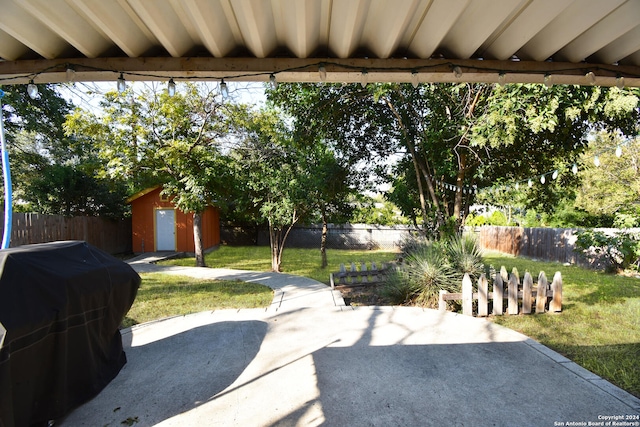 view of patio with a storage unit and grilling area