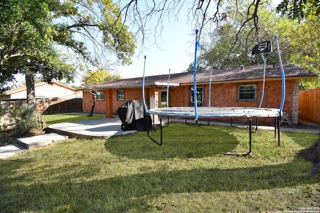 rear view of house featuring a patio and a lawn