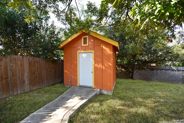 view of outbuilding with a lawn