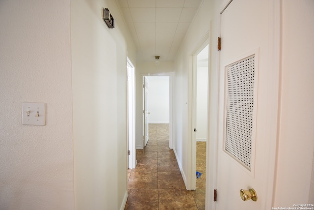 corridor featuring dark tile patterned flooring