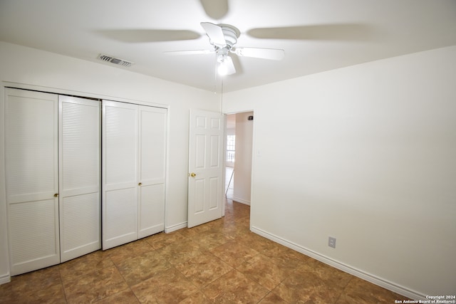 unfurnished bedroom featuring a closet and ceiling fan